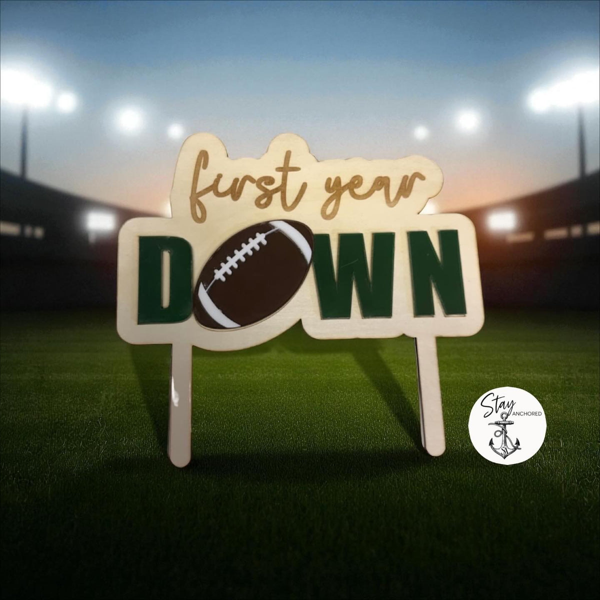 First Year Down football first-birthday cake topper made from engraved wood and layered acrylic