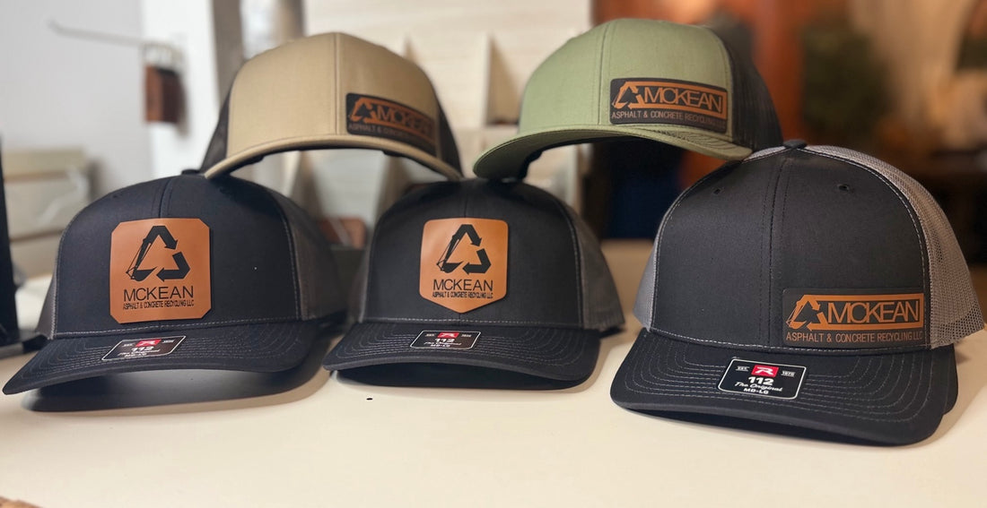 Collection of custom McKean Asphalt and Concrete Recycling business hats