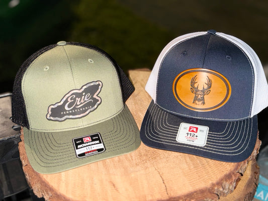 Two finished Stay Anchored patch hats with leather patches